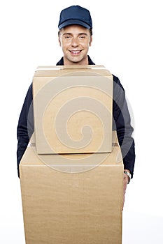 Young man carrying huge cardboard boxes