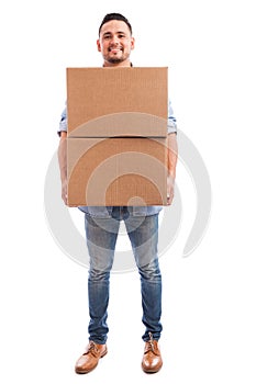 Young man carrying some boxes