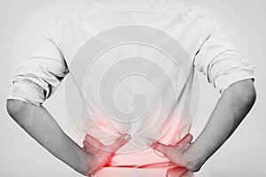 Young man in casual office shirt having hip pain