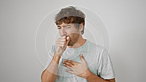 Young man in casual t-shirt coughing, a distressing sign of cold, bronchitis or worse! health care alert on an isolated white