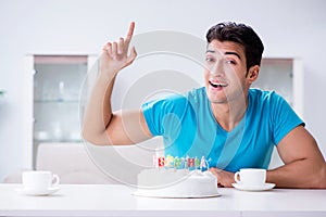 The young man celebrating birthday alone at home