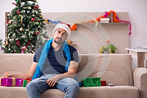 Young man celebrating Christmas at home