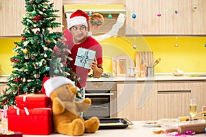 The young man celebrating christmas in kitchen