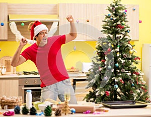 Young man celebrating Christmas in kitchen