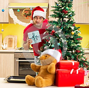 Young man celebrating Christmas in kitchen