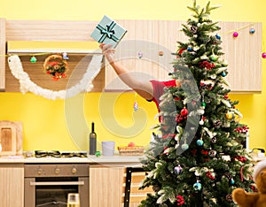 Young man celebrating Christmas in kitchen