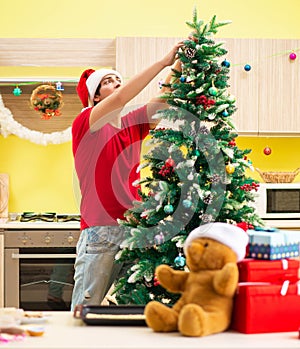 Young man celebrating Christmas in kitchen