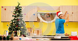 Young man celebrating Christmas in kitchen