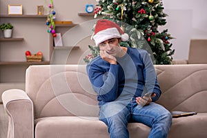 Young man celebrating Christmas alone at home