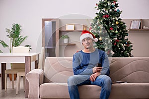 Young man celebrating Christmas alone at home