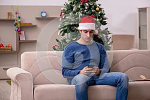 Young man celebrating Christmas alone at home