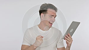 Young Man Celebrating Success on Tablet on White Background