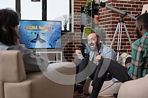 Young man celebrating video games win on tv console