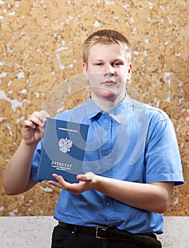 The young man with the certificate about completion of education at school