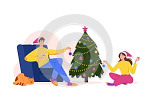 Young man in chair and woman on the floor decorating Christmas tree with baubles and garlands