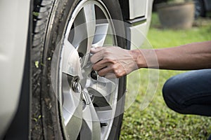 A young man Changing the Wheel