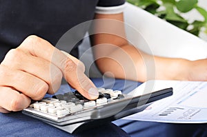 Young man checking a bill, a budget or a payroll