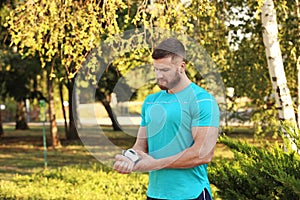 Young man checking pulse after workout