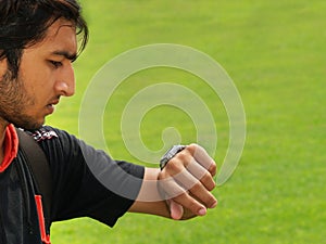 Young Man Checking the Time