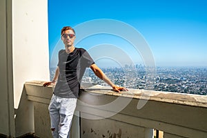 Young man chilling near the Hollywood sign in Los Angeles, USA.