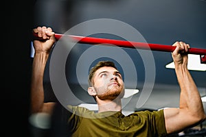 Young man chin pull up at gym