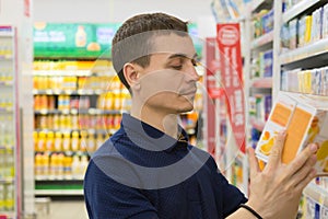 A young man chooses a product in a store.