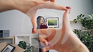 Young man choosing place for picture while girlfriend helping him gesturing