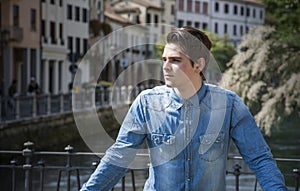 Young man on city bridge in Treviso, Italy
