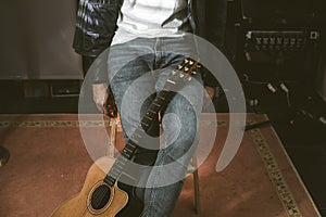 Young man with a classical guitar indoors. Concept Musician guitarist