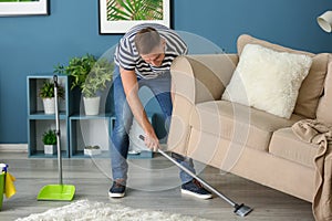 Young man cleaning his flat