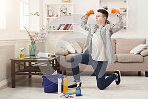 Young man cleaning home and having fun