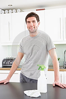 Young Man Cleaning Modern Kitchen