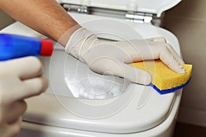 Young man cleaning a toilet