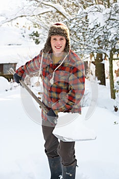 Young man clearing snow photo