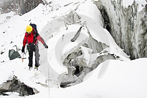 A young man climber traverse a crevasse