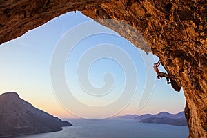 Young man climbing in cave