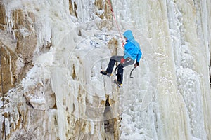 Young man climbing the ice