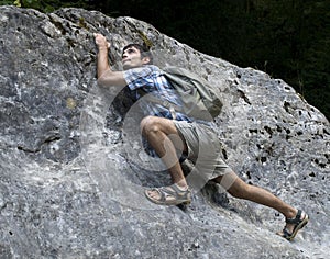 Young man climbing rock