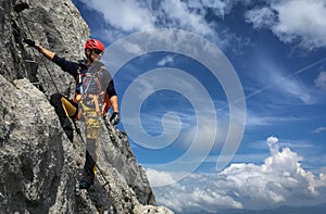 Young man climbing on a rock in Swiss Alps