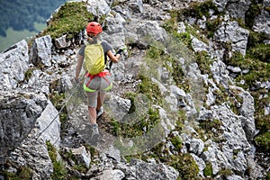 Young man climbing on a rock in Swiss Alps