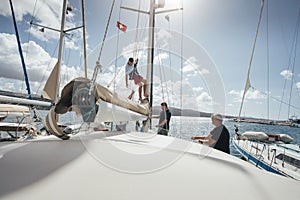 Young man climbing sailboat mast for doing some reparations