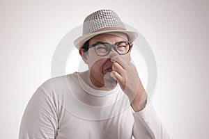 Young Man Close His Nose, Smells Something Bad