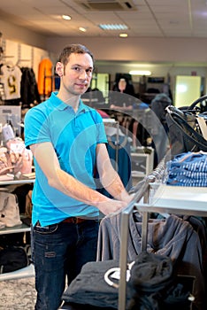 Young man in the clothes shop