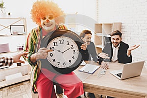 Young Man in Clown Costume on Meeting in Office.