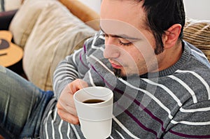 Young man with coffee or tea