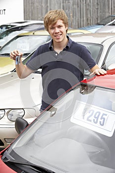Young man collecting new car photo