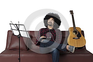 Young man composing song and listening music