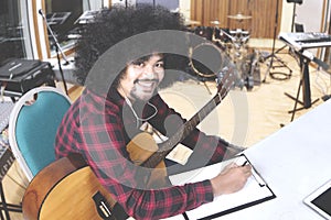 Young man composing song in music studio