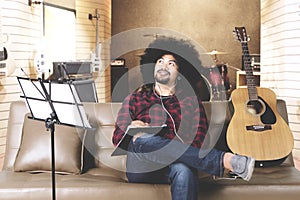 Young man composing a song in music studio