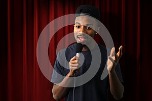 Young man in concert red theater comedy vocalist singer microphone